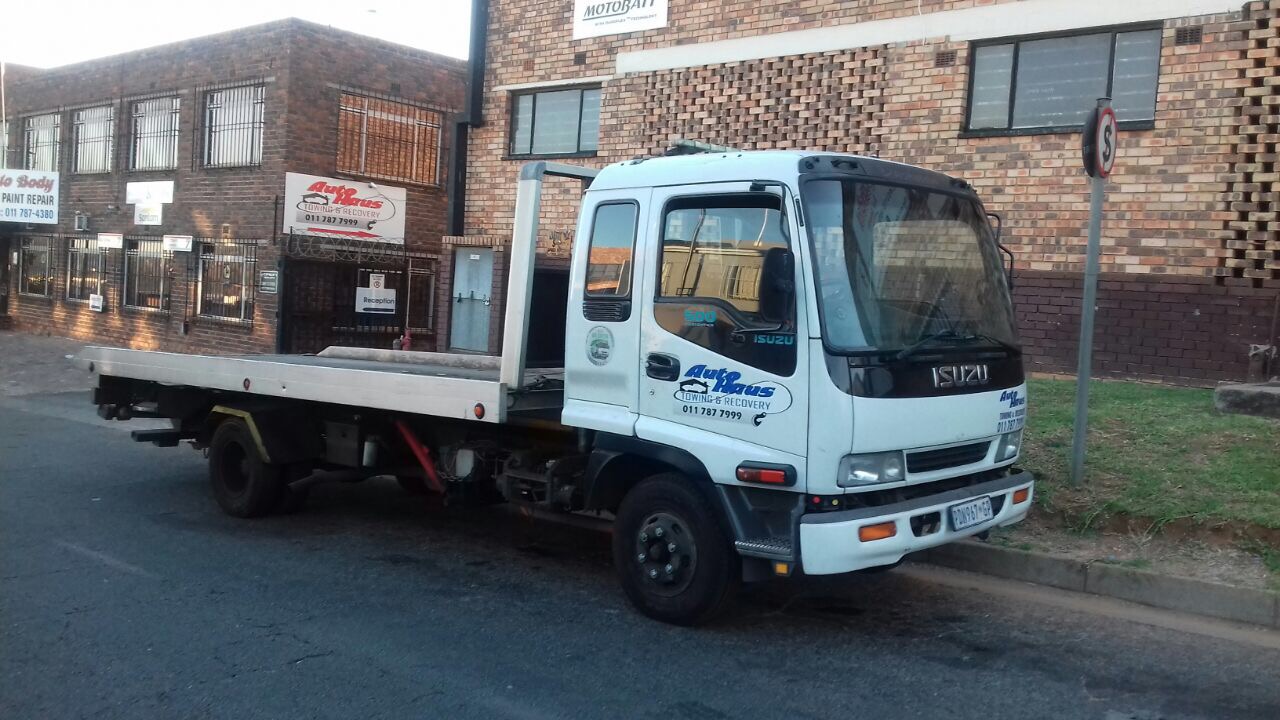 Autohaus flatbed tow truck parked outside the Autohaus premises