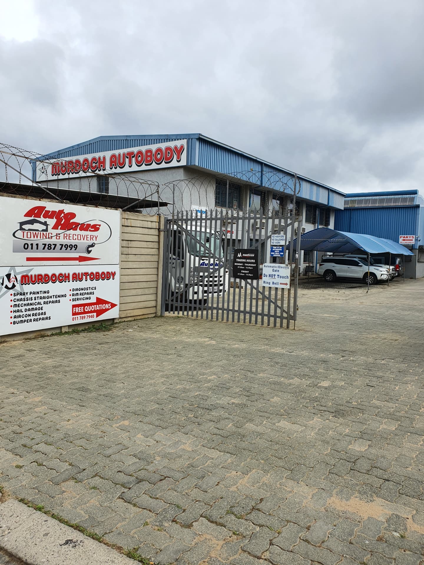 The Autohaus Towing & Recovery sign at the yard entrance in Ferndale