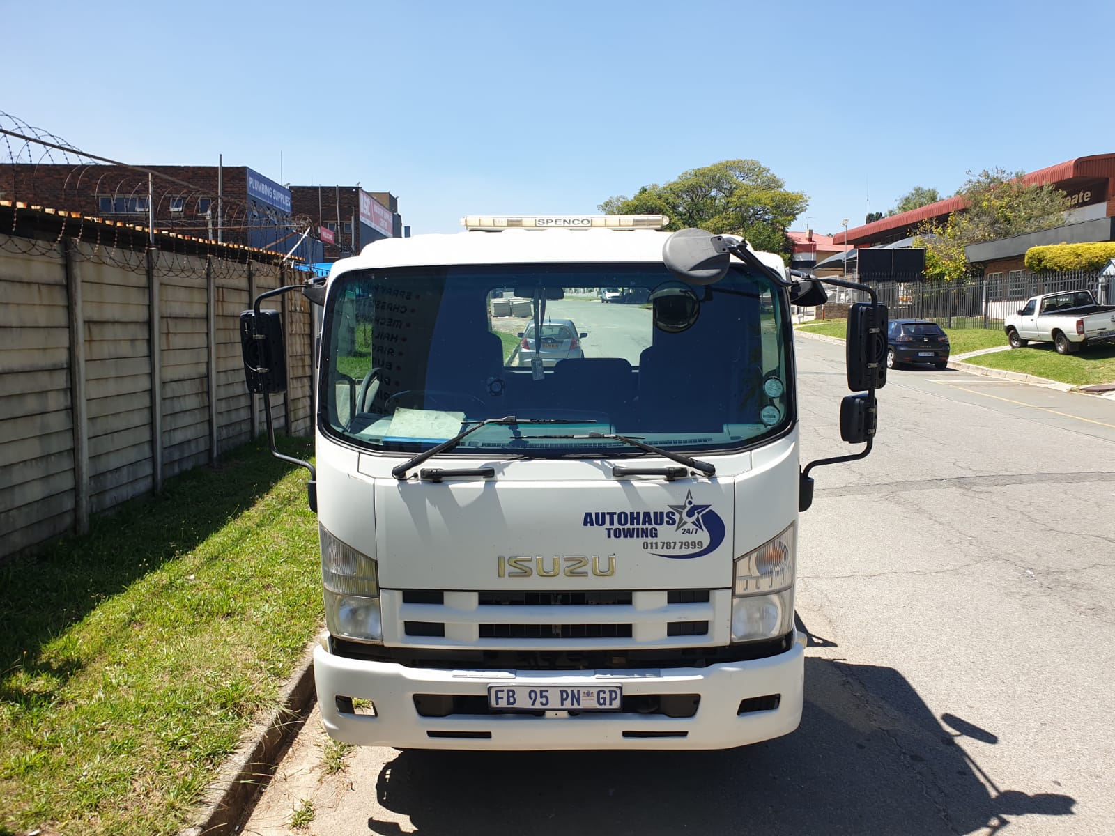 A 5-ton Autohaus Isuzu flatbed tow truck, on call 24/7