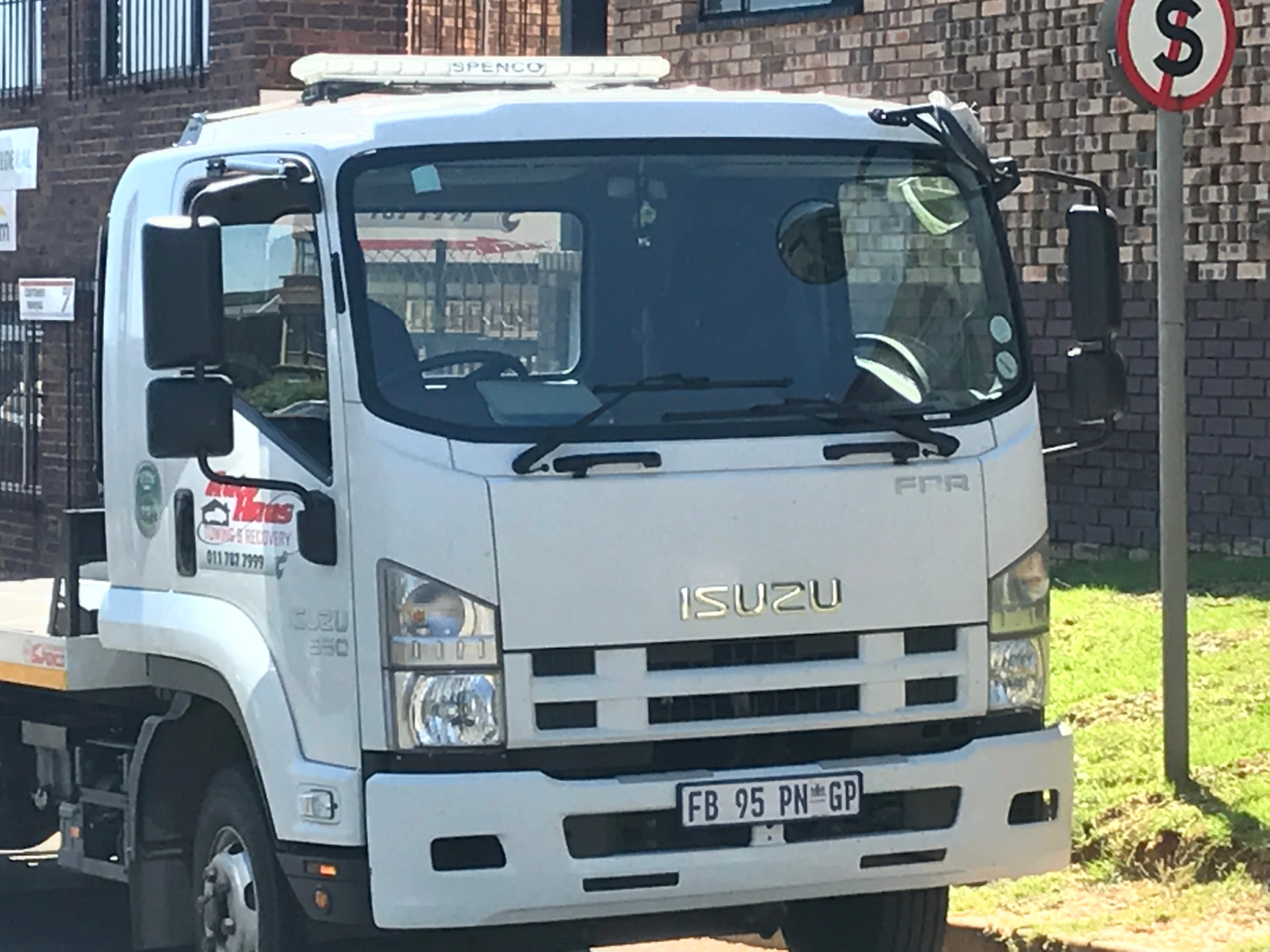 Front view of an Autohaus Isuzu flatbed tow truck